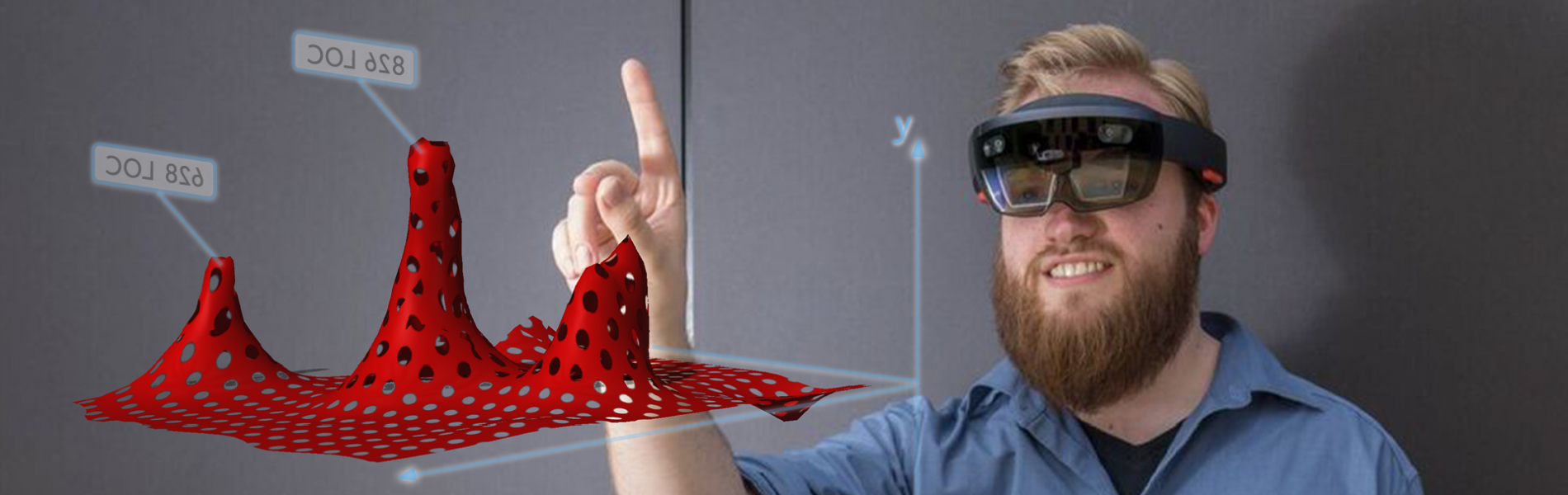 Ein Mann trägt eine VR Brille und zeigt mit dem Finger auf eine Grafik, die im Raum vor ihm erscheint.